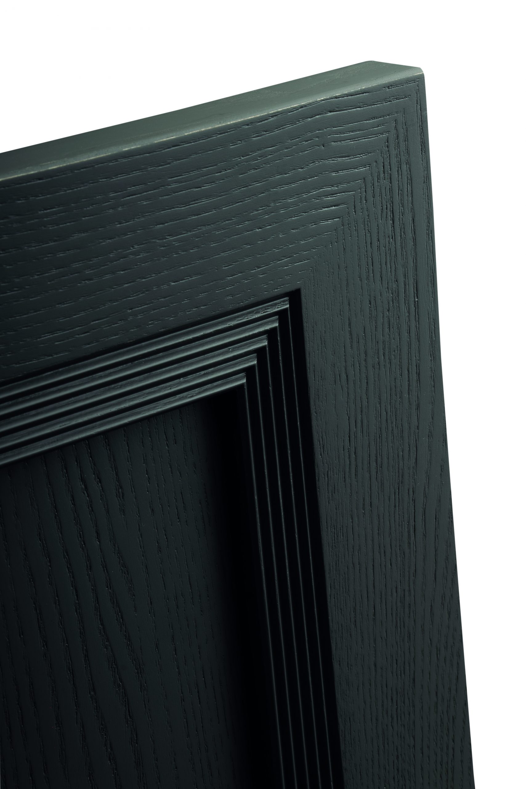 Calpe door in dark-toned ash with stepped mouldings, close-up